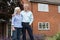 Retired Couple Standing Outside Home