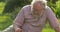 Retired elderly man and dog relaxing outdoors enjoying retirement