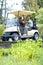 Retired and enjoying lifes small pleasures. A mature couple discussing their last hole while driving a golf cart.