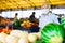 Retired european man wearing medical mask protecting against the virus selling melons and watermelons in market