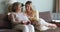 Retired female sit on couch talk to beloved granddaughter