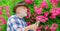 Retired gardener senior portrait, spring banner. Happy farmer in cowboy hat having fun on field. Retirement planning