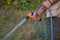 Retired gardener watering the garden with hose.