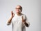 Retired Indian old man eating ice cream, standing icolated against white background