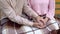 Retired man covering wife hands, pensioner couple resting together in garden