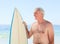 Retired man with his surfboard