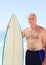 Retired man with his surfboard