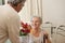 Retired man offering flowers to his wife