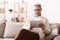 Retired man reading book on tablet at home