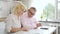 Retired man and woman calculating bills at home.