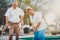 Retired married elderly couple playing mini golf together