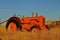 Retired old orange tractor