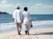 retired ouple white dressed walking on the beach