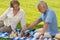 Retired senior couple playing chess in park