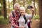 Retired Senior Couple Posing For Selfie On Mobile Phone Hiking In Woodland Countryside 