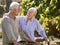 Retired Senior Couple Working In Vegetable Garden Or Allotment Carrying Tray Of Beets