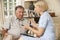 Retired Senior Man Having Health Check With Nurse At Home