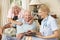 Retired Senior Man Having Health Check With Nurse At Home