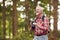 Retired Senior Man Hiking In Woodland Countryside Taking Photo With DSLR Camera