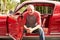 Retired Senior Man Sitting In Restored Classic Car