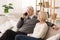Retired senior man talking on phone, having rest with wife