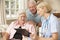 Retired Senior Woman Having Health Check With Nurse At Home