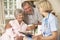 Retired Senior Woman Having Health Check With Nurse At Home