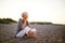 Retired woman in the beach making phone call