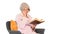 Retired woman reading a book sitting on a chair on white backgro