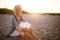 Retired woman sitting on the beach