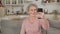 Retired woman speaks and smiles into smartphone camera