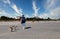 Retiree Walking Dogs Down Beach