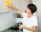 Retiree woman cleaning home