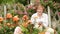 retiree woman gardening bush roses