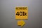 Retirement 401k write on a sticky note isolated on office desk