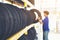 Retirement man touching and choosing for buying a tire in a supermarket mall. Measuring rubber car wheel