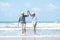 Retirement Travel. Asian Lifestyle senior couple dancing on the beach happy and relax time.