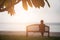 Retirement Vacation Concept. women retired sitting alone on chair that have the sea background.