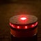 A retractable bollard with a red warning light as a barrier to a pedestrian area at night in Bansin, Germany.