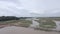 Retreating drone shot of a small bamboo bridge over a flooded field