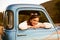 Retro 1950s teen in classic blue truck