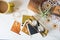 Retro 1970s Themed Still Life with Brass Hourglass Polaroids and Pyrex mug