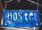 Retro aged blue signboard with inscription hostel