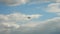 Retro airplane flying against a blue sky with dark storm clouds. sun rays are breaking through the clouds