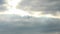 Retro airplane flying against a blue sky with dark storm clouds. sun rays are breaking through the clouds