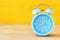 Retro alarm clock over yellow background