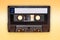 Retro audio cassette tape on yellow background