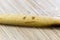 Retro authentic wood dough rolling pin with burns like sad smiley face