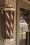 Retro barber shop pole attached to historic building
