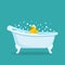 Retro bathtub with a rubber yellow duckling toy in the foam